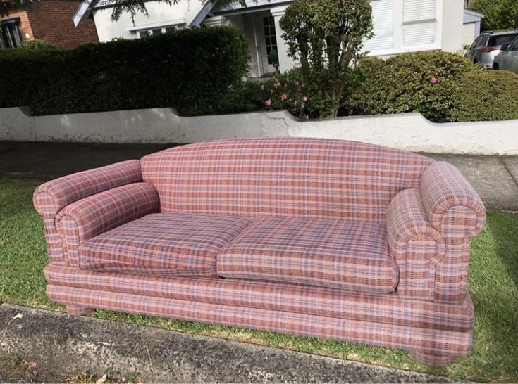 Worn three seater sofa with faded fabric and sagging cushions before repair
